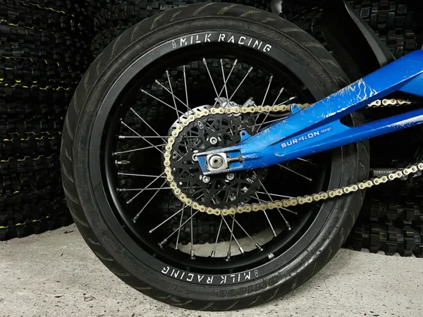 The 16" SuperMoto rear wheel is mounted on a Surron e-bike with ON-ROAD tires.
